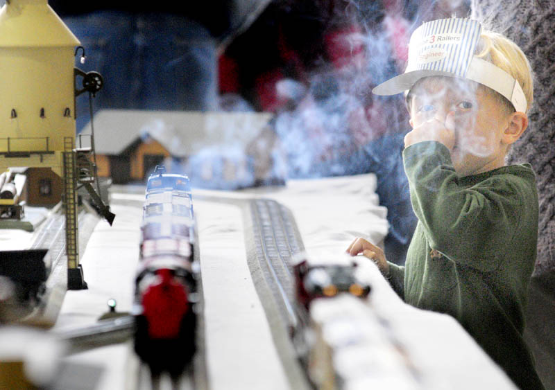 Jaden Desmarais, 7 of Searsport, doesn't like the smell of the smoke coming off a model train running through a display on Friday at the Maine State Museum in Augusta.