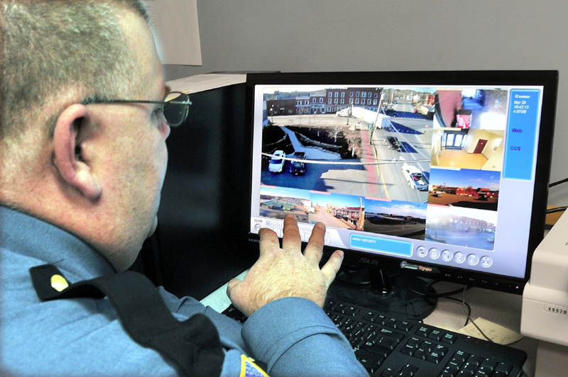 Skowhegan Interim Police Chief Dan Summers looks at eight different live videos taken from surveillance cameras placed in downtown Skowhegan, on Thursday.