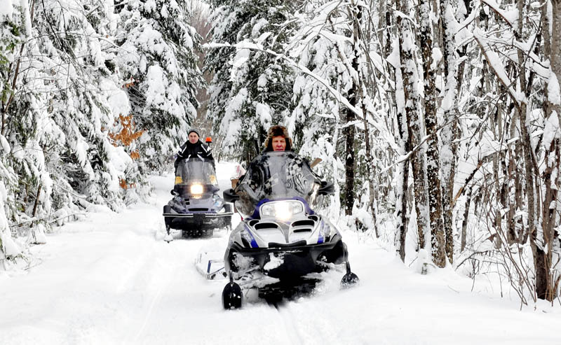 Ernie Rice, front, and Dennis Harris, both members of the Belgrade Draggin Masters club, groom snowmobile trails through the Belgrade woods on Sunday. The early and abundant snow is a blessing for area snowmobilers.