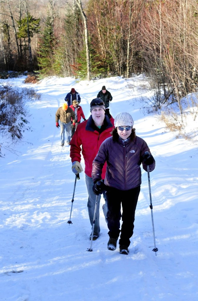 Part of a large group of hikers, including Eva and Jeff Cole, hike toward the Stratton Brook Hut, the fourth building in the Maine Huts and Trails system in Carrabassett Valley, which was formally opened on Wednesday.