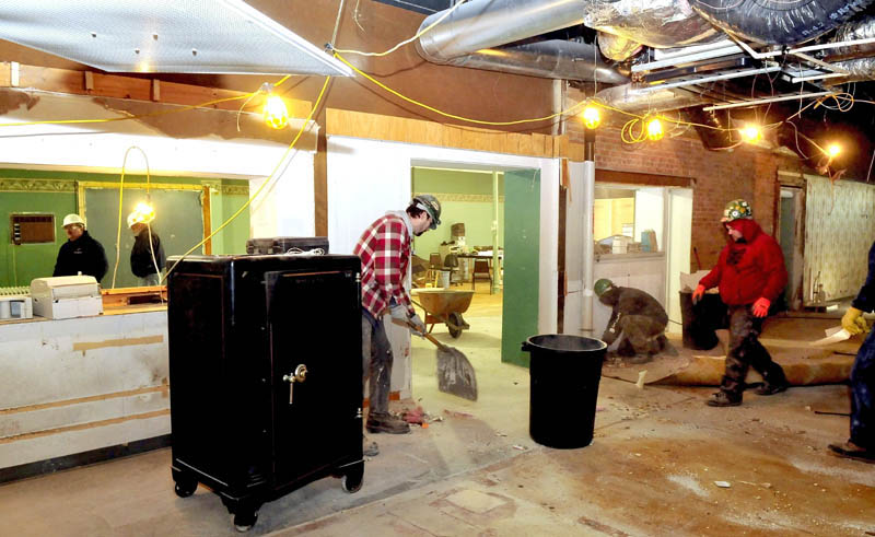 Sheridan Construction workers remove carpet, tile, electrical fixtures and molding from the office area in the former Gerald Hotel in Fairfield on Thursday. The building will be turned into senior housing.