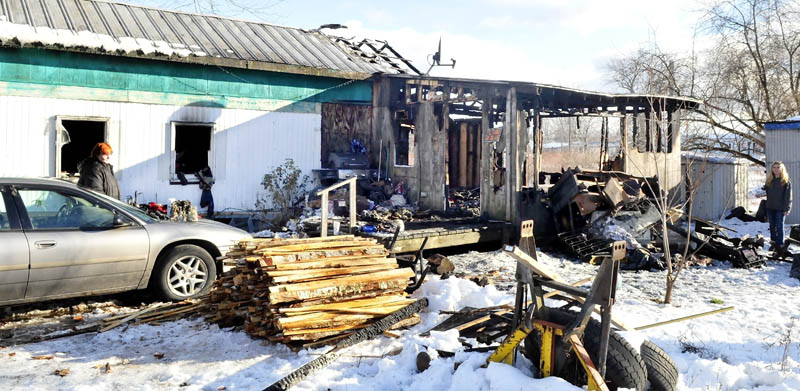 LOST HOME: Home owner Margaret Torrance, left, looks at the remains of her mobile home on Thursday, which was destroyed by fire earlier in the day. A wood stove fire caused the blaze.