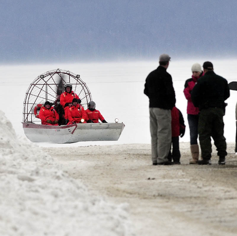 Maine Warden Service personnel return to shore in an airboat on Rangeley Lake on Monday, after motoring over ice. Wardens said Dawn Newell's body was recovered Monday after the snowmobile she was riding broke through the ice Sunday night.