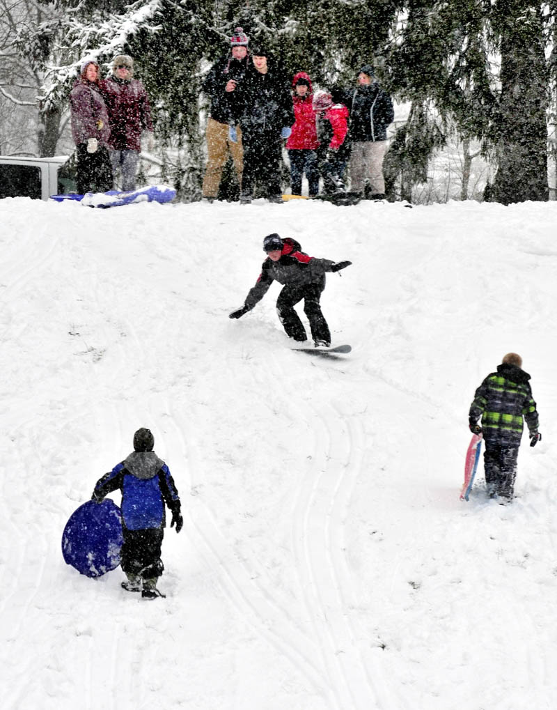 Students broke out sleds and snowboards to enjoy the fresh snowfall on a hill at the Good Will-Hinckley grounds in Fairfield on Monday.