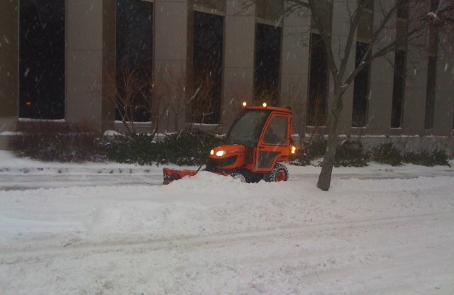 A city plow clears a sidewalk near Monument Square in Portland early Thursday morning, Dec. 27, 2012.