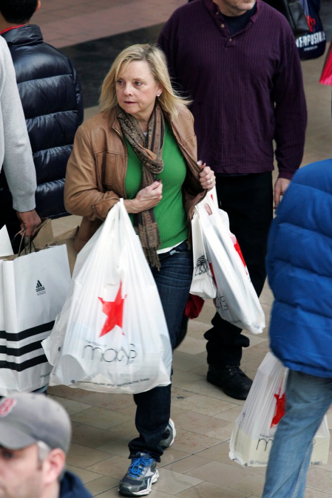 A last-minute Christmas shopper dashes through the Willowbrook Mall in Wayne, N.J., on Sunday. Shoppers seem to be spending less this holiday season, analysts said.