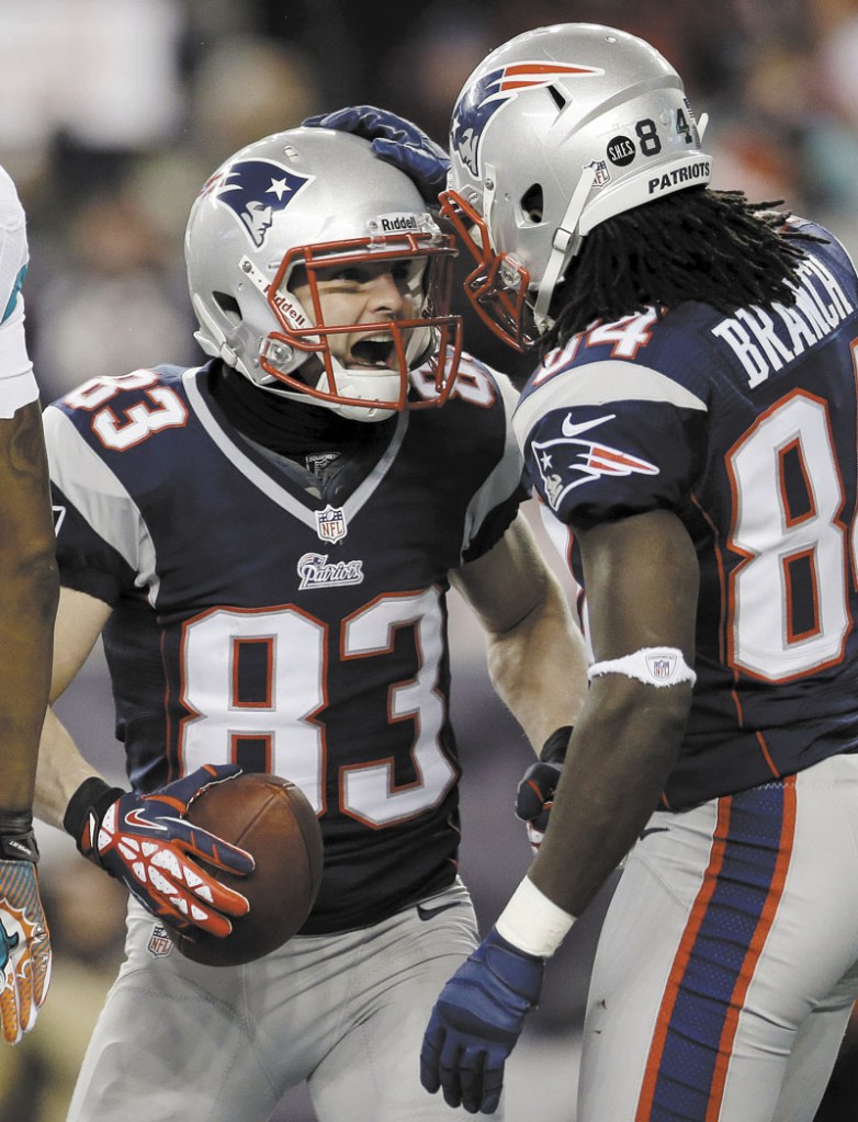 HEY, ALL RIGHT: New England Patriots wide receiver Wes Welker (83) celebrates his touchdown catch with Deion Branch during the first quarter Sunday in Foxborough, Mass. NFLACTION12; Gillette Stadium