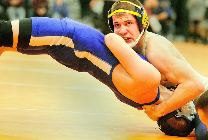 Staff photo by Joe Phelan BRIDGE: Mt. Blue’s Kevin Moore, top right, works on pinning Erskine Academy’s Joe York on way to winning the 132-pound championship match of the Tiger Invitational on Saturday in the James A. Bragoli Memorial Gym in Gardiner.