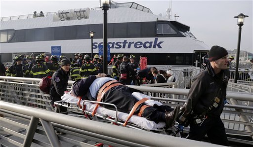An injured passenger from the Seastreak Wall Street ferry is taken to an ambulance in New York on Wednesday. The ferry from Atlantic Highlands, N.J., banged into the mooring as it arrived at South Street in lower Manhattan during morning rush hour.