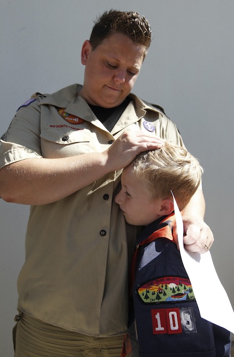 n this July 18, 2012 file photo, Jennifer Tyrrell hugs her son Cruz Burns, 7, outside Boy Scouts national offices in Irving, Texas, after a meeting with representatives of the 102-year-old organization. The Ohio woman was ousted as a den mother because she is a lesbian. The Boys Scouts of America announced Monday, Jan. 28, 2013, that it is considering a dramatic retreat from its controversial policy of excluding gays as leaders and youth members. (AP Photo/LM Otero, File)