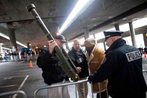 Seattle police officers examine a surface-to-air missile launcher brought to the gun buyback program.