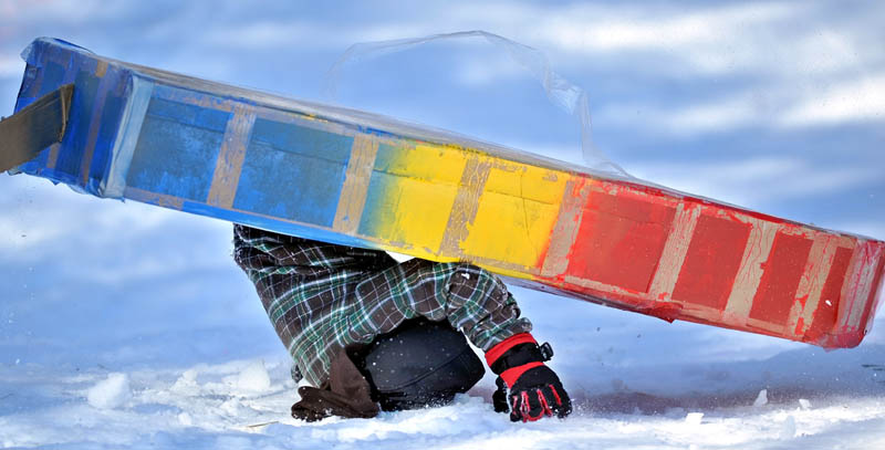 Cameron Louder flips his cardboard sled during the cardboard sled races at Lake George Regional Park during last year's Winter Carnival.
