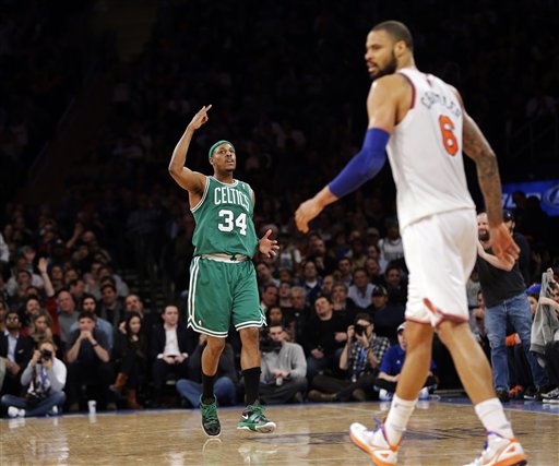 Boston Celtics forward Paul Pierce (34) reacts to a score as New York Knicks center Tyson Chandler walks by in the second half Monday at Madison Square Garden in New York. Pierce led with 23 points as the Celtics won 102-96.