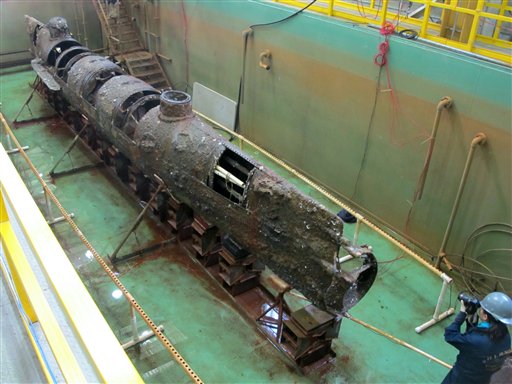 The Confederate submarine H.L. Hunley sits in a conservation tank in North Charleston, S.C. Scientists say a pole on the front of the sub designed to plant explosives on enemy ships may hold a key clue to its sinking during the Civil War.