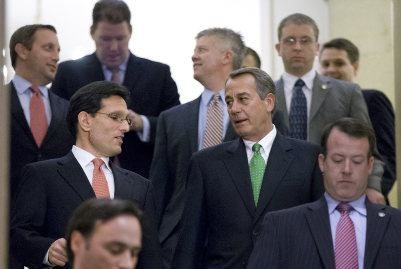 Speaker of the House John Boehner, R-Ohio, center right, and House Majority Leader Eric Cantor, R-Va., center left, walk down stairs to a second Republican conference meeting to discuss the "fiscal cliff" bill, which was passed by the Senate Monday night, at the Capitol in Washington on Tuesday.
