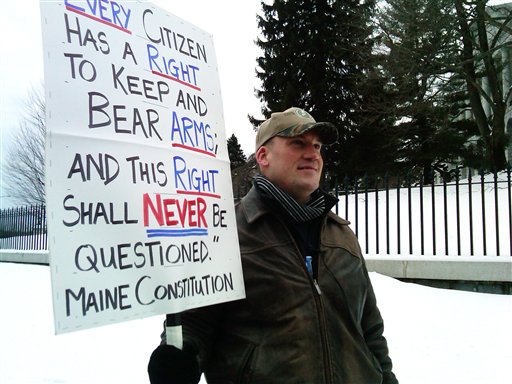 Michael Hein, of Augusta, holds a sign in front of the Maine State House during a Gun Appreciation Day rally on Saturday, Rallies were held nationwide Saturday by gun-rights advocates, four days after President Barack Obama unveiled a sweeping plan to curb gun violence.