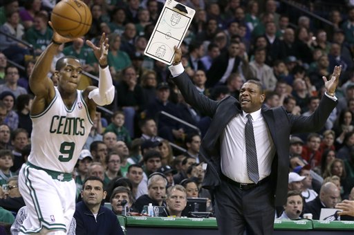 Boston Celtics head coach Doc Rivers, right, gestures for a time out as Boston Celtics point guard Rajon Rondo handles the ball with under a minute left in the second quarter of a game against the New Orleans Hornets on Jan. 16, 2013.