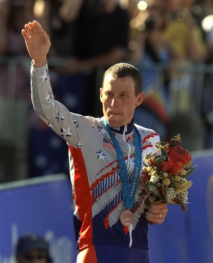 In this Sept. 30, 2000, photo, Lance Armstrong waves after receiving the bronze medal in the men's individual time trials at the 2000 Summer Olympics cycling road course in Sydney, Australia.