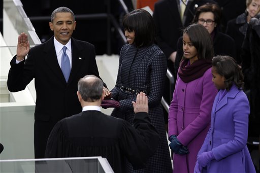 President Barack Obama receives the oath of office from Chief Justice John Roberts as first lady Michelle Obama and his daughters Malia and Sasha listen at the ceremonial swearing-in at the U.S. Capitol on Monday.