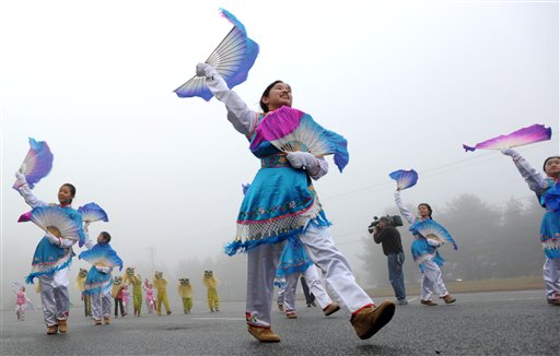 Hali Jiang, center, practices with the Chinese American Community Center Folk Dance Troupe in "The Dance of the Golden Snake," in Hockessin, Del., on Sunday, for their performance in the presidential inauguration parade on Monday.