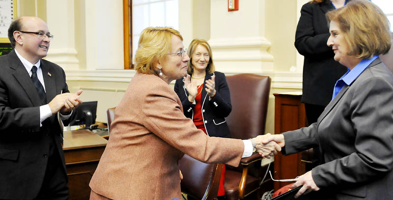Attorney General Janet Mills, center, greets Pola Buckle, who was sworn in as state auditor, on Monday in Augusta. Matt Dunlap, left, was sworn in as secretary of state and Neria Douglass, third from left, was sworn in as state treasurer during a ceremony in the House of Representatives.