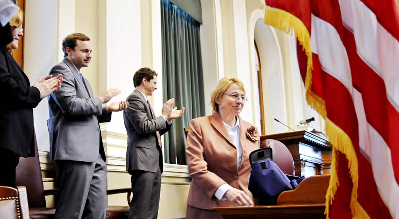 Incoming Attorney General Janet Mills is applauded by Maine Senate President Justin Alfond, second from right, Speaker of the House Mark Eves and Maine Supreme Judicial Court Chief Justice Leigh Saufley during Monday ceremonies at the House of Representatives.