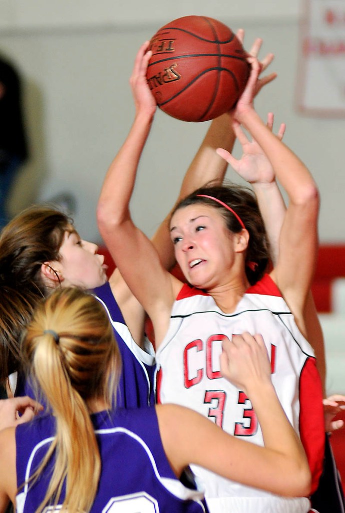 Cony High School’s Josie Lee grabs a rebound against Hampden Academy on Wednesday in Augusta. Lee finished with 16 points as Cony won 57-41. For local roundup, see C3.