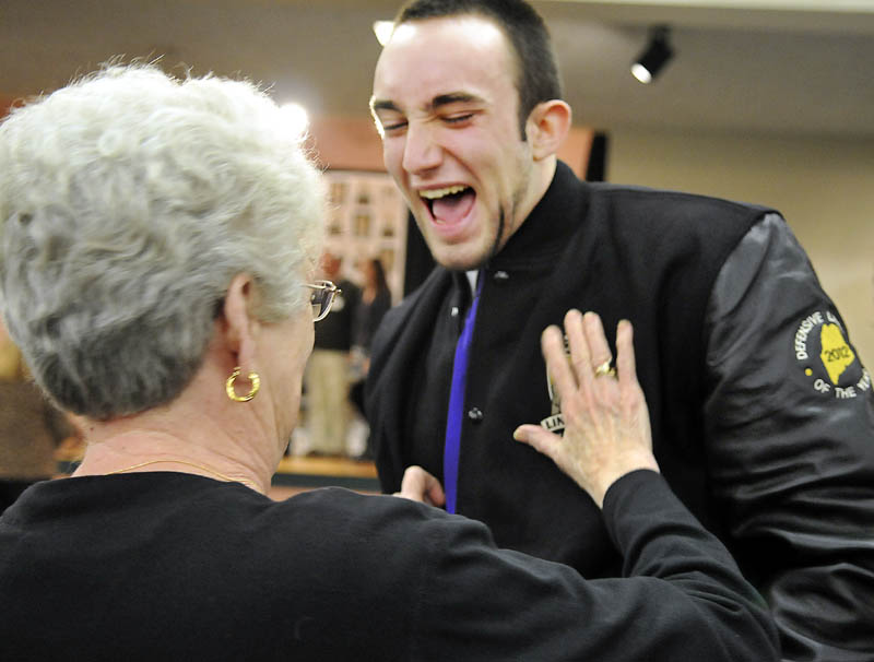 TAKE THAT: 2012 Gaziano Defensive Lineman award winner Kurt Massey, of John Bapst High School, laughs as his grandmother, Pat Massey, touches his award jacket Sunday in Augusta.