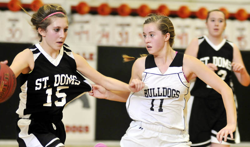 CLOSELY DEFENDED: Hall-Dale High School’s Nicole Pelletier, right, defends St. Dominic Academy’s Kelly Pomerleau on Thursday in Farmingdale.