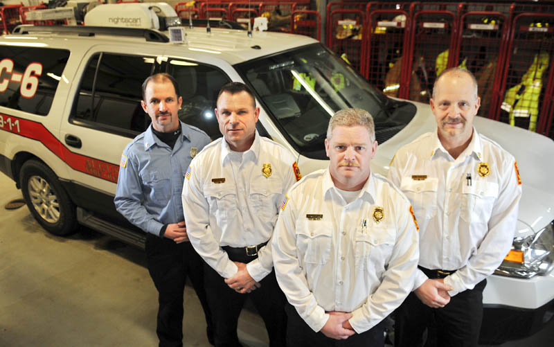 Augusta Fire Department's new officers, Lt. Jason Farris, left, Battalion Chief John Bennett, Deputy Chief David Groder and Battalion Chief Scott Dunbar, with the new incident command vehicle at Hartford Station on Wednesday.