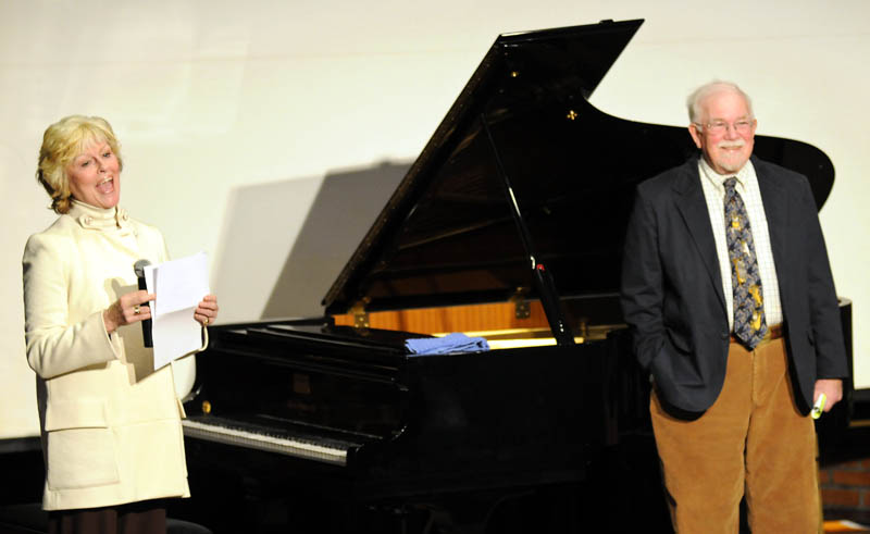 University of Maine at Augusta President Allyson Handley thanks the school's Senior College after Tom Feagin, a director at the Senior College, right, donated a piano to the University of Maine at Augusta on Sunday.