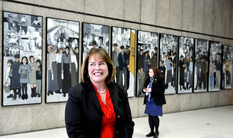 Jeanne Paquette, Maine's commissioner of labor, unveiled the labor murals on display on the wall of the Cultural Building atrium that serves as the entryway to the Maine State Museum in Augusta Monday January 14, 2013. The murals were hung over the weekend after being removed by Gov. Paul LePage in 2011 from the Department of Labor.