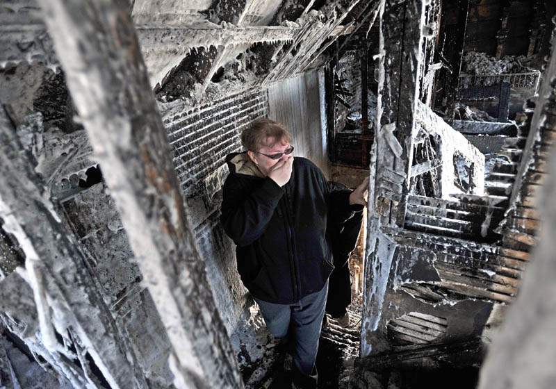 Becky Williams, 40, becomes emotional as she looks at the second floor her parents' Madison Avenue home, which was destroyed by fire around 3 a.m. Friday. "I can't believe no one was hurt," Williams said, through her the hand over her mouth as she fought back tears.