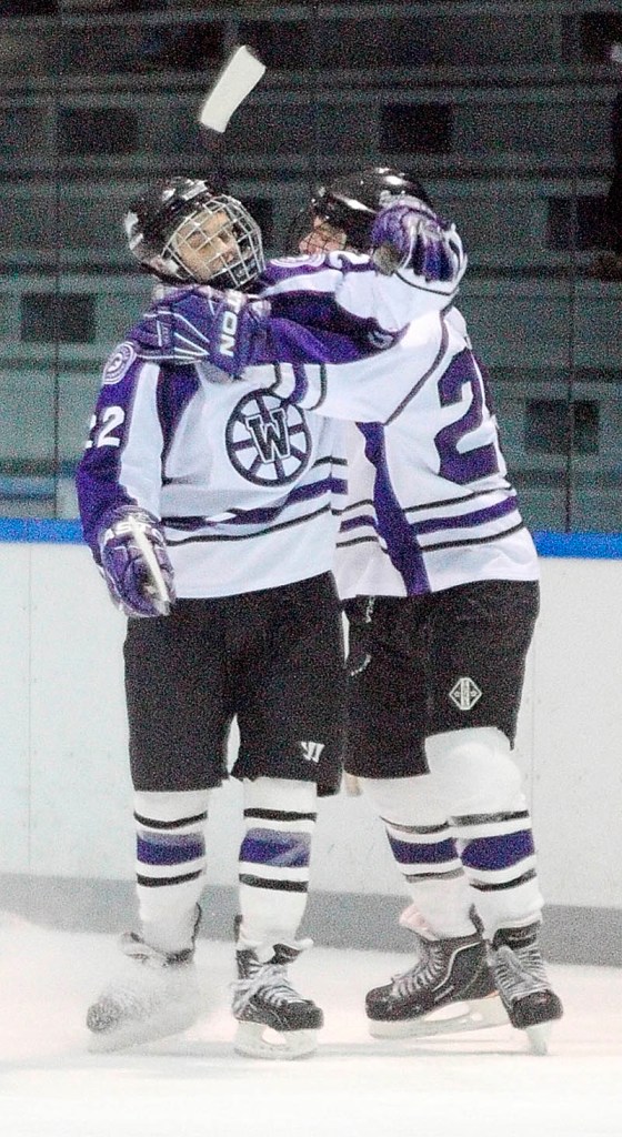 NICE JOB: Waterville junior forward Denis Dalton, left, gets a hug from teammate junior defenseman Todd Serbent after Dalton scored the Panthers first goal of a game against MHW on Thursday at Colby College in Waterville.