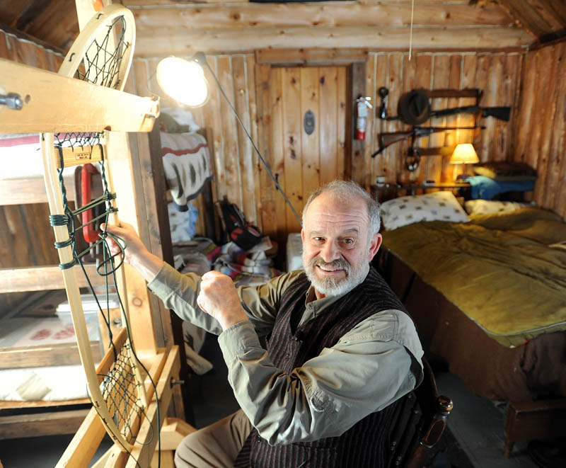 Dave Giampetruzzi, 63, of China, a 43-year veteran with the U.S. Army, fabricates a snowshoe in his cabin at Pine Grove Lodge in Bingham on Thursday. Giampetruzzi teaches snowshoe making for the Pine Grove Program, which hosts veterans and service members on select weekends for wilderness adventures. The Pine Grove Program is a nonprofit program designed to help disabled veterans and service members get outdoors for hunting, fishing and wilderness activities. The program is primarily funded through snowshoe sales.