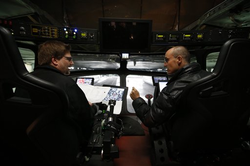 Electrical engineer Varoujan Sarkissuan, left, and aerospace engineer Munir Jojo chat in the cockpit of the Aeroscraft.