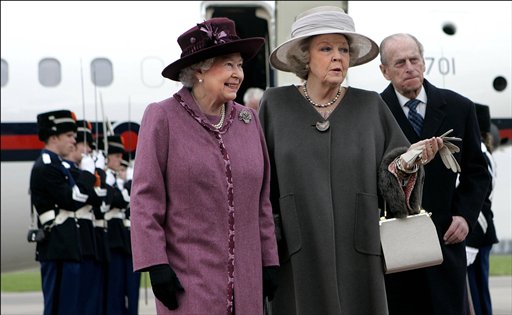 In this 2007 photo, Queen Beatrix, center, greets Britain's Queen Elizabeth II, left, and Prince Philip, right, at Rotterdam airport, Netherlands.