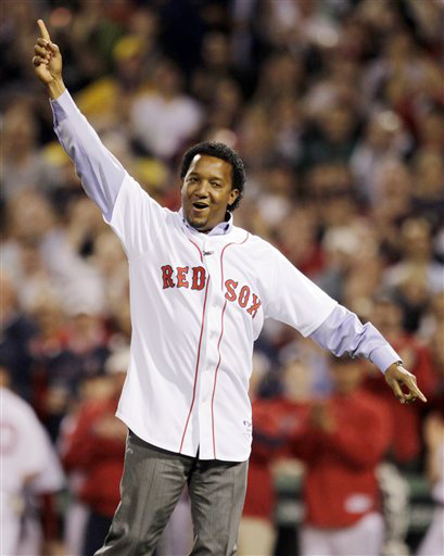 Former Boston Red Sox pitcher Pedro Martinez celebrates after throwing the ceremonial first pitch before the Red Sox' 2010 season opener against the New York Yankees.