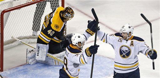 Buffalo Sabres left wing Thomas Vanek, right, of Austria, is congratulated by teammate Jason Pominville after beating Boston Bruins goalie Tuukka Rask, rear, during the third period of an NHL hockey game in Boston, Thursday, Jan. 31, 2013. Vanek scored three goals in the Sabres' 7-4 win. (AP Photo/Charles Krupa)