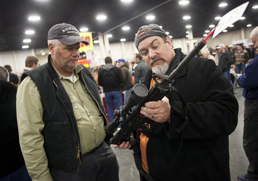 Gun owners discuss a potential sale of an AR-15, one of the most popular and controversial weapons, during the 2013 Rocky Mountain Gun Show at the South Towne Expo Center in Sandy, Utah, on Saturday. An Obama administration task force led by Vice President Joe Biden plans to offer recommendations this month on how to curb gun violence in the wake of the mass shooting at an elementary school in Newtown, Conn.