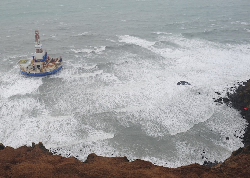 This aerial image provided by the U.S. Coast Guard shows the Royal Dutch Shell drilling rig Kulluk aground off a small island near Kodiak Island Tuesday Jan. 1, 2013. No leak has been seen from the drilling ship that grounded off the island during a storm, officials said Wednesday, as opponents criticized the growing race to explore the Arctic for energy resources. (AP Photo/U.S. Coast Guard)