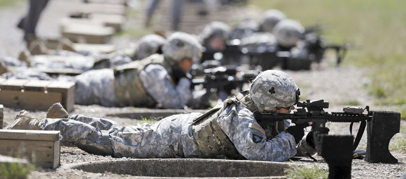 Female soldiers from 1st Brigade Combat Team, 101st Airborne Division train on a firing range while testing new body armor in Fort Campbell, Ky., in preparation for their deployment to Afghanistan. The Pentagon is lifting its ban on women serving in combat, opening hundreds of thousands of front-line positions and potentially elite commando jobs after generations of limits on their service, defense officials said Wednesday.