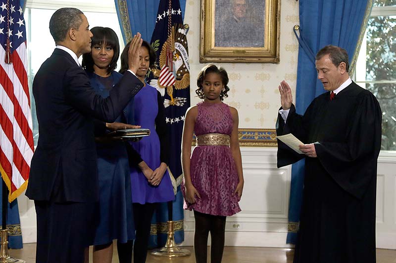 President Barack Obama is officially sworn in by Chief Justice John Roberts in the Blue Room of the White House during the 57th Presidential Inauguration in Washington on Sunday. Next to Obama are first lady Michelle Obama, holding the Robinson Family Bible, and daughters Malia and Sasha.