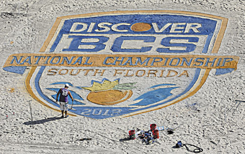 MAKING ART: An artist puts the finishing touches on the BCS National Championship logo on the beach Sunday in Fort Lauderdale, Fla. Notre Dame takes on Alabama for the national championship tonight in Miami.