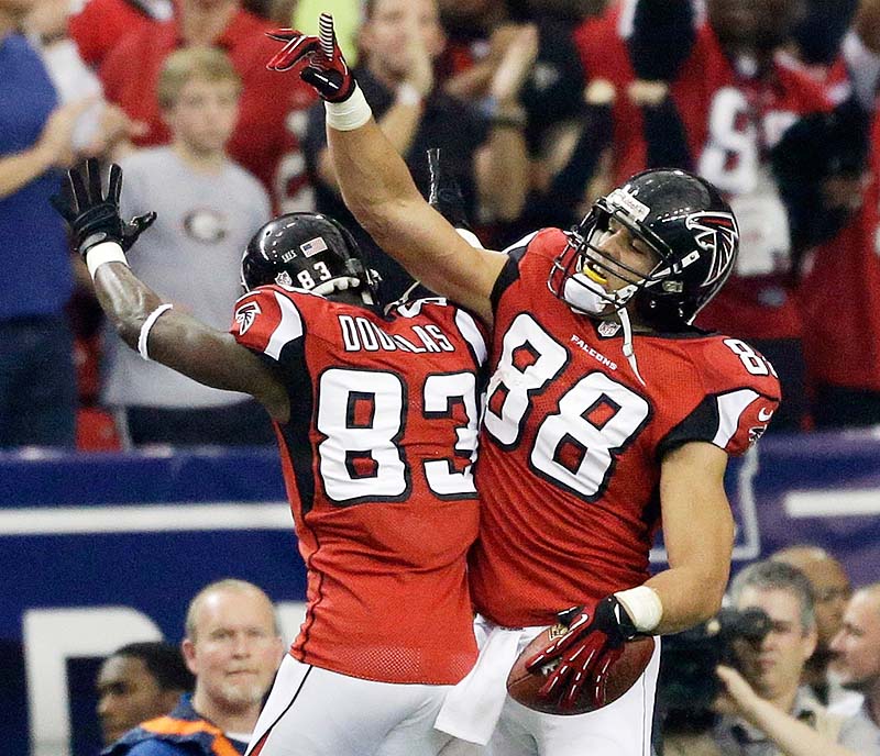Atlanta Falcons tight end Tony Gonzalez, right, celebrates his touchdown with Harry Douglas in the first half of Sunday's NFC playoff game against Seattle at Atlanta.