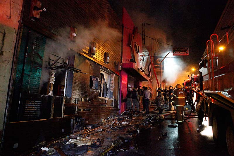 Firefighters work to locate and assist survivors after an early-morning fire at the Kiss Club in Santa Maria, Brazil, on Sunday. The latest death toll was at 233, officials said.