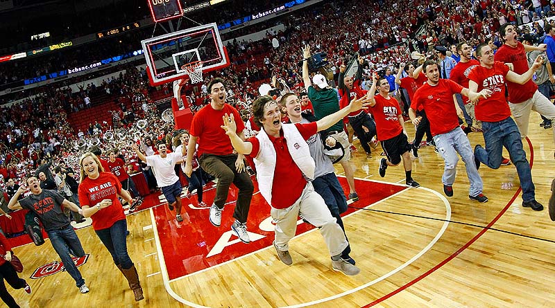 North Carolina State fans rush the court following the Wolfpack's 84-76 win over top-ranked Duke in Raleigh, N.C. Saturday.