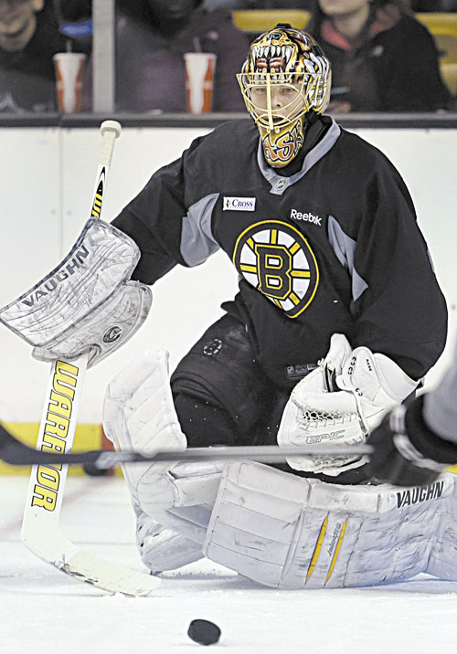 BACK AT IT: Boston goaltender Tuukka Rask keeps his eye on the puck during a practice Sunday at the TD Garden, in Boston.