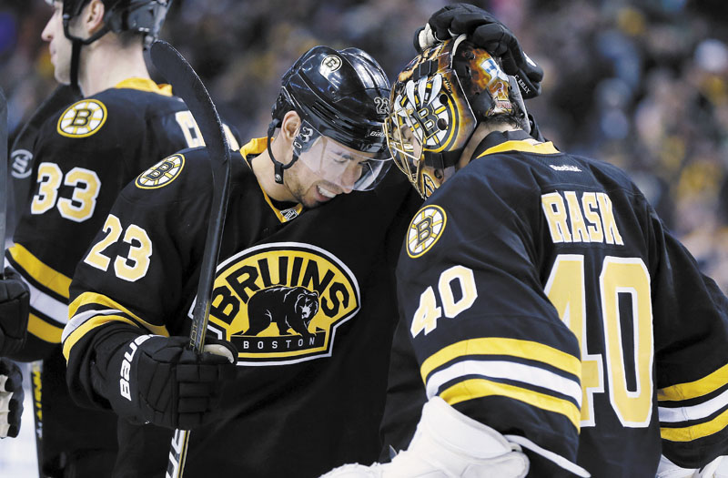 NICE WIN: Boston’s Chris Kelly (23) celebrates with goalie Tuukka Rask after the Bruins defeated the Winnipeg Jets 2-1 in a shootout Monday in Boston.
