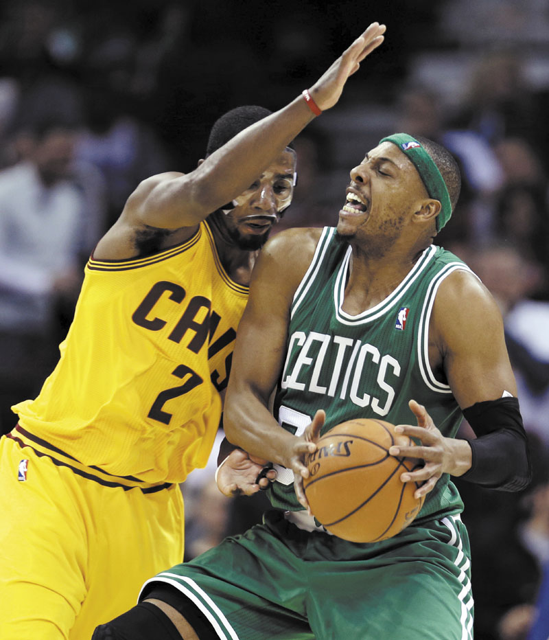 Boston Celtics' Paul Pierce, right, is stopped by Cleveland Cavaliers' Kyrie Irving during the second quarter of an NBA basketball game, Tuesday, Jan. 22, 2013, in Cleveland. (AP Photo/Tony Dejak) Quicken Loans Arena